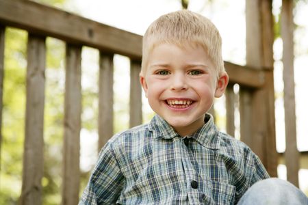 Close-up of a small cute blond boy looking natural and happyの写真素材