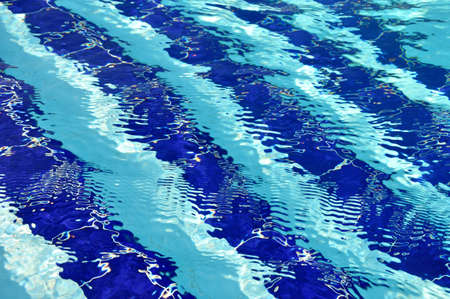 Specks of light in the pool with blue water