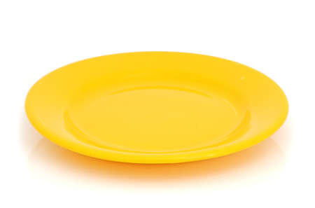 A yellow kitchen plate on the white backgroundの写真素材