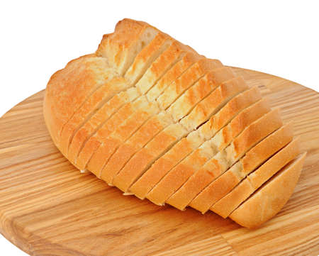 Slices of bread from wheat flour on the wood breadboard