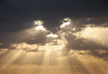 Sky and clouds. A face from a sunlight on the sky. Natural photographing in storm weather.