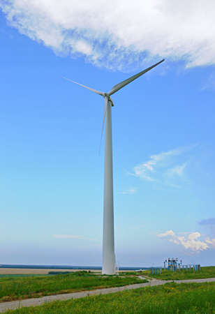 Wind-powered generator against the blue sky