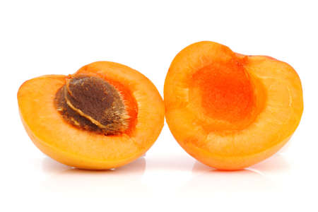 Ripe apricot with a pit on a white backgroundの写真素材