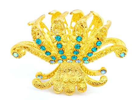 Gold hair clip with decorative stones on a white backgroundの写真素材