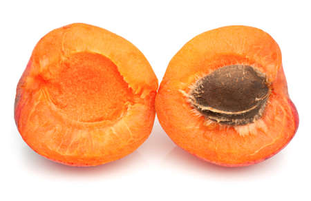 Ripe apricot with a pit on a white backgroundの写真素材