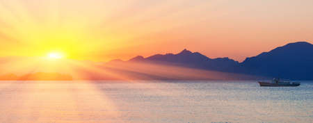 Sea and mountains against a sunset  Summer seascape 