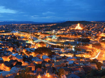 Capital of Georgia - Tbilisi at night against the dark blue sky