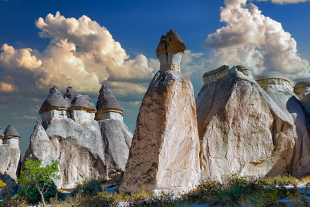 Natural stone statues against a picturesque cloudy sky in the evening in Cappadocia. Goreme National Park, district of Nevsehir, Kapadokya, Turkeyの写真素材