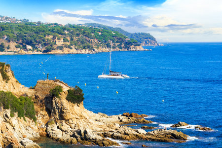 Picturesque landscape of the Mediterranean Sea and mountains within the city of Lloret de Mar in sunny day. Costa Brava, Girona, Catalonia, Spainのeditorial素材