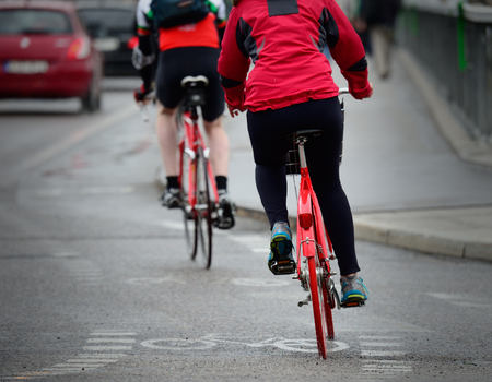 Persons on bikes seen from behind.の写真素材