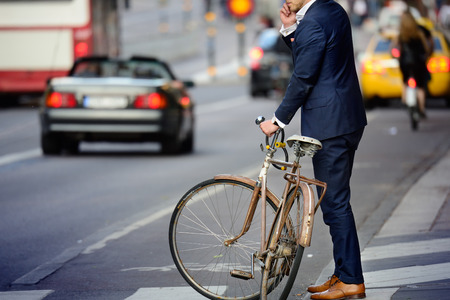 Man in perfect suit and old bike, typical Stockholm Scene Man in perfect suit and old bike, typical Stockholm Scene