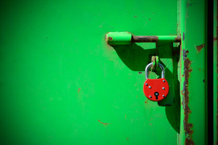 Red padlock and very green door