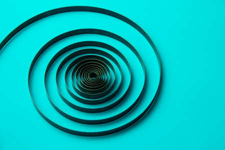 Ð¡lock spring on a blue background, metal spiralの写真素材