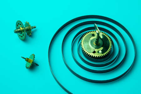 Clock spring with gears on a blue background, metal spiralの写真素材