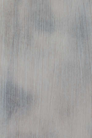 Wooden board painted in light color with dark spotsの写真素材