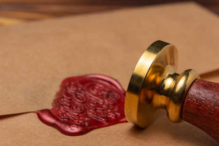 Wax seal with metal stamp on envelopeの写真素材