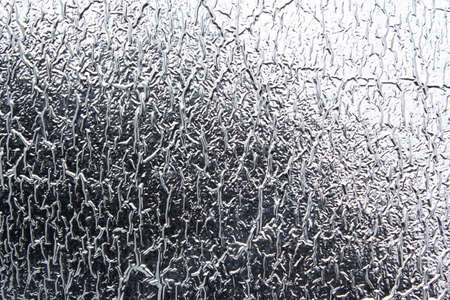 Texture of aluminum foil with folds, abstract background