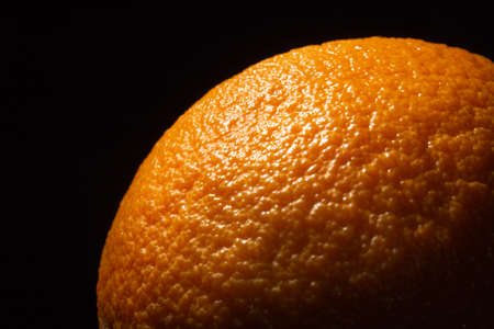 Orange in the dark close up, orange skin textureの写真素材