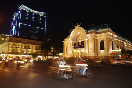 Ho Chi Minh at night, modern and old buildings, motorbikes passing by  Black sky  Saigon, Vietnam のeditorial素材