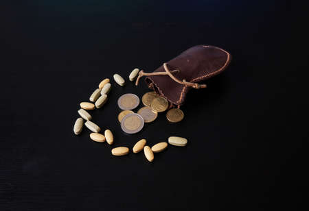 The Cost of Relief close up: A closer view of the cost of pain relief and health care. Miney and pillsの写真素材