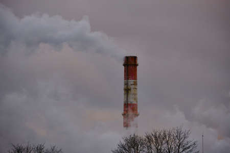 Air pollution, closeup of one big smoking pipe