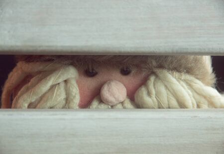 santa claus hidden behind a chairの写真素材