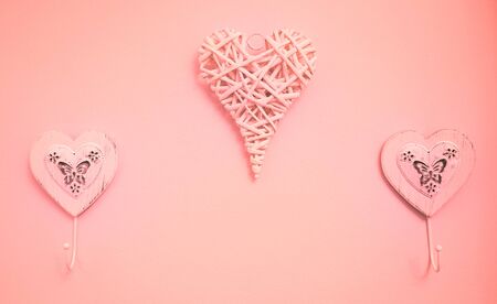 hearts hangers hanging on a pink wallの写真素材