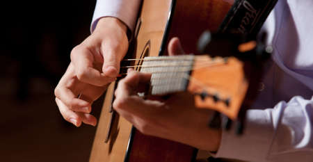 A young man playing a quitarの写真素材