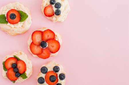 Anna Pavlova cake with strawberries, blueberries and cream cheese. Top view, place for text, concept of love sweetの写真素材