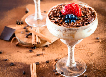 tiramisu in a glass decorated with strawberry on a dark backgroundの写真素材