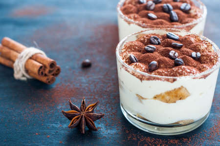 tiramisu in a glass decorated with coffee beans on a dark backgroundの写真素材