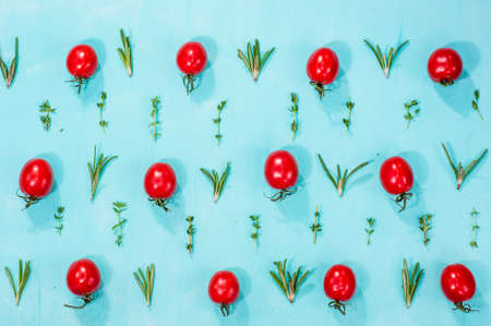 cherry tomatoes pattern with rosemary and thymeの写真素材