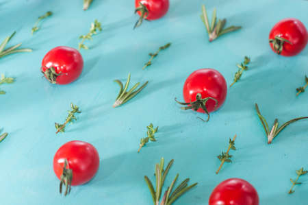 cherry tomatoes pattern with rosemary and thymeの写真素材