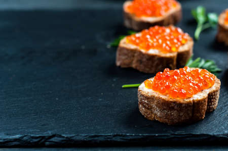 Red caviar on slate background.の写真素材