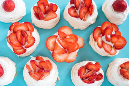 Homemade small strawberry pavlova meringue cakes with cream top viewの写真素材