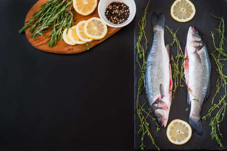 fresh seabass, lemon and spices on the tableの写真素材