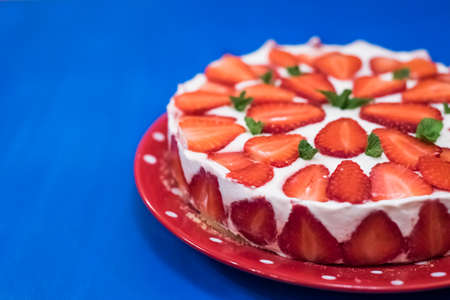 Strawberry cake with sour cream on a blue backgroundの写真素材