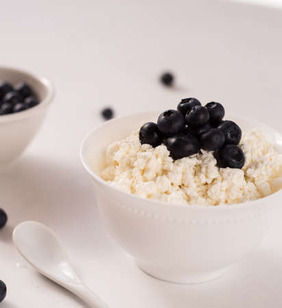 Cottage cheese with blueberries on woodの写真素材