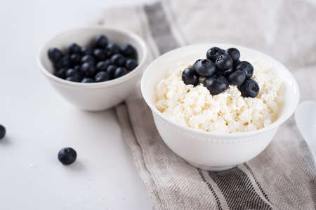 Cottage cheese with blueberries on woodの写真素材
