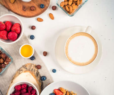 Breakfast table with oatmeal porridge, croissants, fresh fruit overhead shotの写真素材