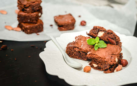 Sliced homemade brownies on white plate. Served on rectangle white plate. Favorite chocolate dessert for chocolate lover. Sweet and moist of cocoa taste. Top view.の写真素材