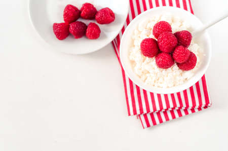 Fresh cottage cheese with juicy berries raspberries, dietary breakfast for summer time selective...