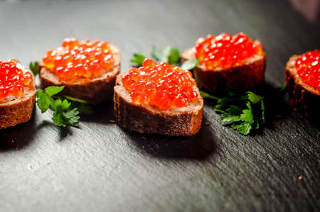 red caviar on black bread with butter. Healthy food. Fish appetizer.の写真素材