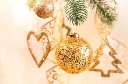 Gold Christmas tree ball on a Christmas treeの写真素材