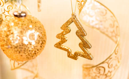 Gold Christmas tree ball on a Christmas treeの写真素材
