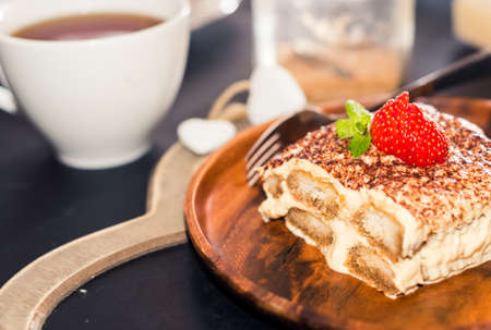 Homemade tiramisu cake decorated with strawberries Italian cuisineの写真素材