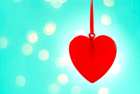 Christmas Ornament heart on white background of New Year's lightsの写真素材