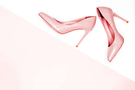 Pink female shoes on white background. Flat lay, top view trendy fashion feminine background.の写真素材