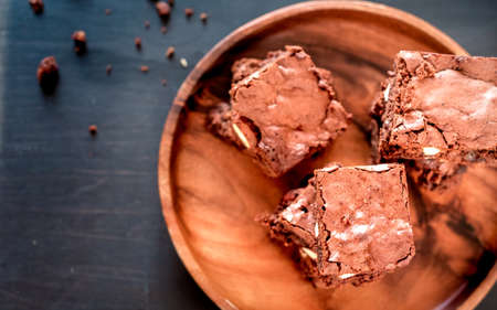 brownie chocolate cake on a wooden plate top view, space for textの写真素材