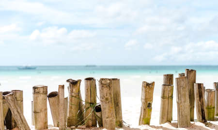 Bamboo fence and tropical transparent sea water texture reflections on a tropical beach of the Philippines Boracayの写真素材